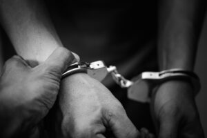 **Alt text:** Hands being placed in handcuffs during an arrest, illustrating cases defended by Cincinnati criminal defense lawyers.